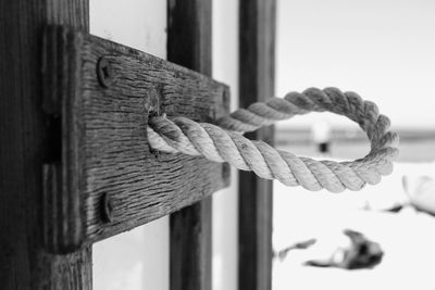 Close-up of rope tied on wooden post