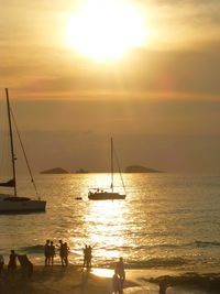 Sailboat in sea at sunset