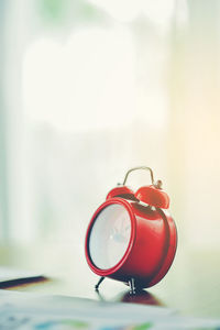 Close-up of red clock on table