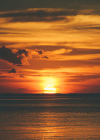 Scenic view of sea against romantic sky at sunset