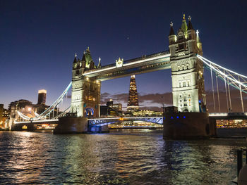 View of bridge over river at night