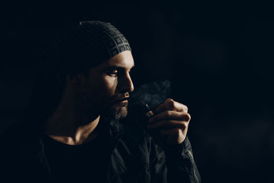 Portrait of man smoking cigarette