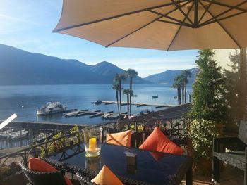 Chairs by sea against sky