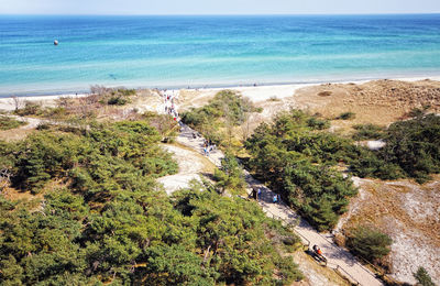 High angle view of trees and sea against sky