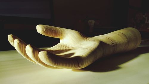 Close-up of human hand on table at home