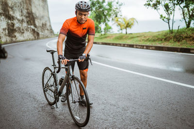 Man riding bicycle on road