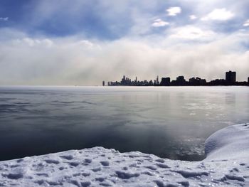 Scenic view of snow covered landscape against cloudy sky