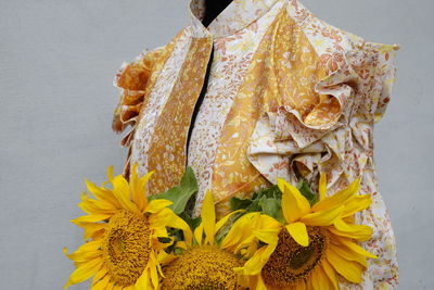 Close-up of dress and yellow flowers