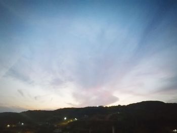 Scenic view of silhouette mountains against sky at sunset