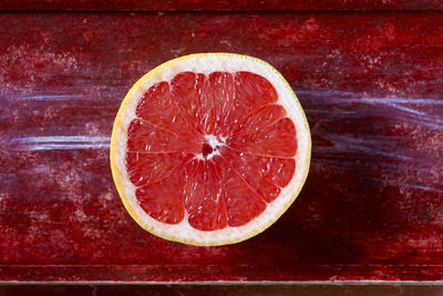 Close-up of strawberry against red background