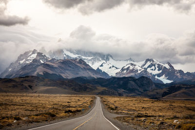 Scenic view of mountains against cloudy sky