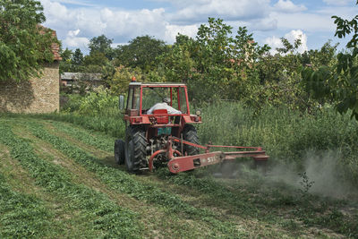 Tractor on agricultural field against sky