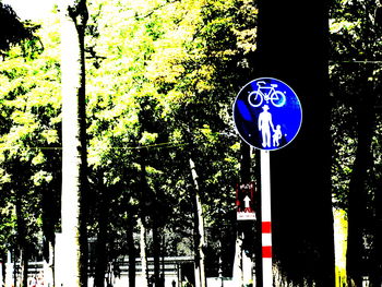 Low angle view of road sign against trees