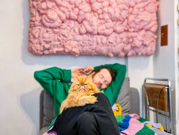 High angle view of young woman standing on table