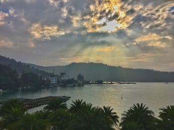 Scenic view of lake against cloudy sky