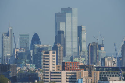 Modern buildings in city against clear sky