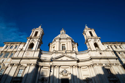 Low angle view of historic building against blue sky