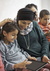 Family using digital tablet at home