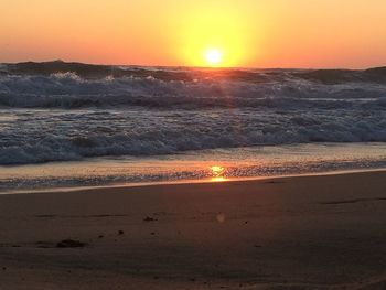 Scenic view of beach against sky during sunset