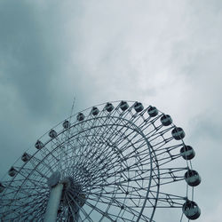 Low angle view of ferris wheel against sky