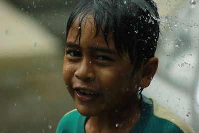 Close-up portrait of boy in rainy season7