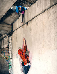 High angle view of woman standing by wall