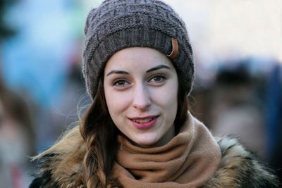 Close-up portrait of woman wearing knit hat