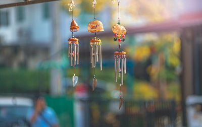 Close-up of illuminated lanterns hanging on metal