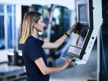 Engineer working on cnc machine in factory