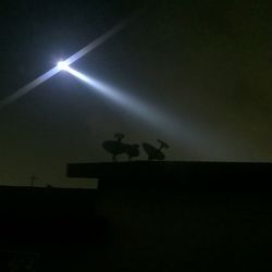 Low angle view of illuminated building against sky at night