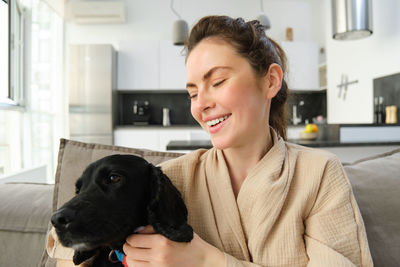 Side view of young woman looking at home