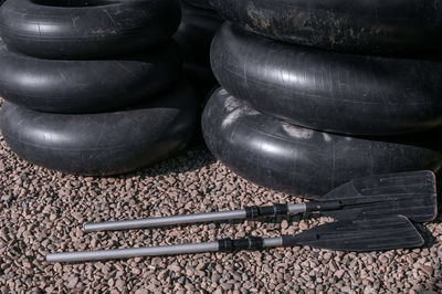 Black plastic kayak paddle and black swim ring