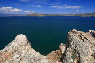 Scenic view of sea and mountains against sky