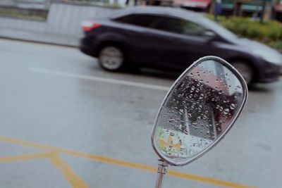 Close-up of wet car on street