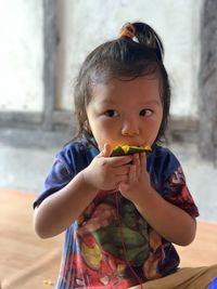 Portrait of cute boy eating food