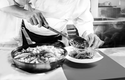 Midsection of man preparing food