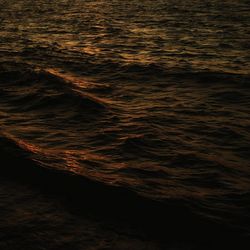 Close-up of sea waves at sunset
