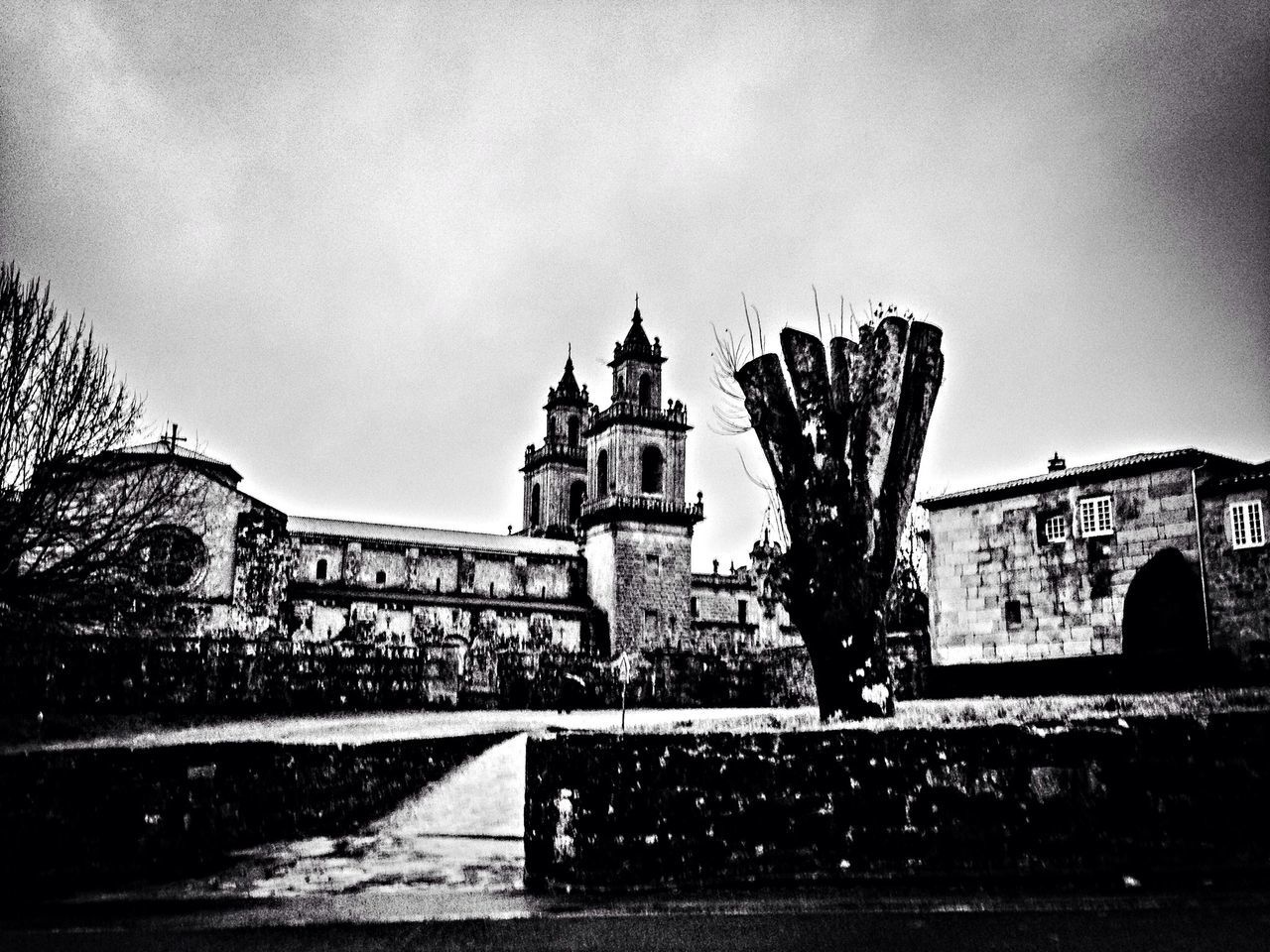 architecture, built structure, building exterior, sky, low angle view, building, city, history, day, tree, old, outdoors, bare tree, clear sky, no people, railing, street, wall - building feature, gate, water