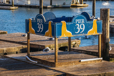 Text on pier against sea