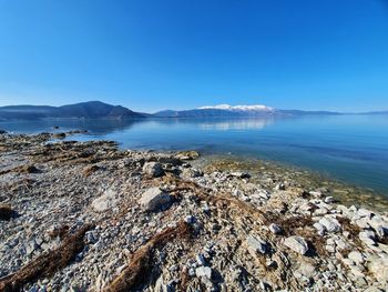 Scenic view of sea against clear blue sky