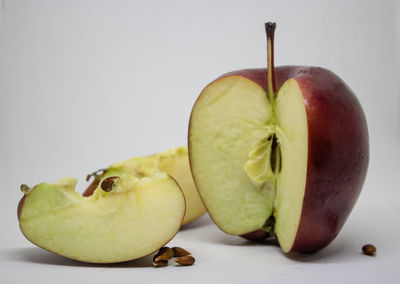 Close-up of apple on table against white background