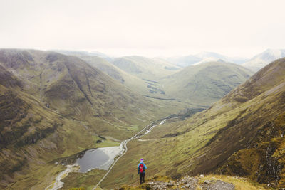 High angle view of man walking on mountain against sky