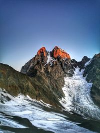 Scenic view of snowcapped mountains against clear sky