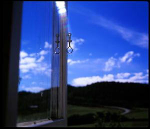 Close-up of silhouette window on field against sky