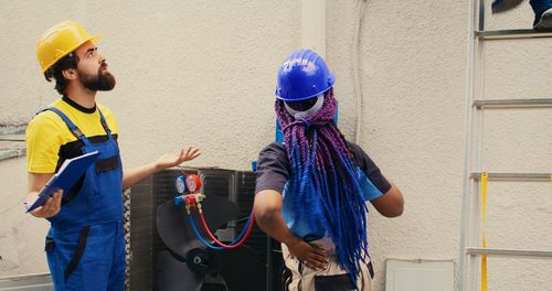 Rear view of woman standing against wall