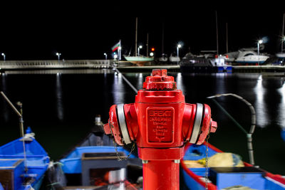 Illuminated red boat in river at night