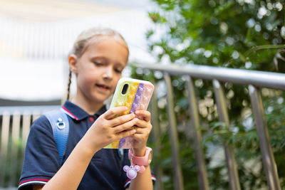 Happy girl using mobile phone