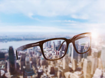 Close-up of sunglasses against sky