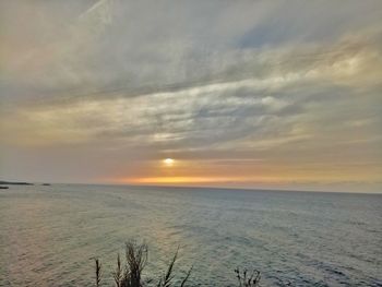 Scenic view of sea against cloudy sky