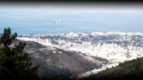 Aerial view of cityscape against sky